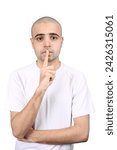 Small photo of Young Asian Boy keeping finger on his lips gesturing silent on standing White background, asking to keep silence. A Man keep index finger on his lips. Be silent. Concept of keeping a secret.