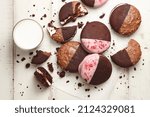 Small photo of American whoopie pie desserts on white wooden planks, top view