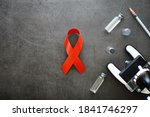 Small photo of Symbol of human immunodeficiency virus disease. Red ribbon. A helping hand and support. Background.