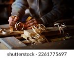 Small photo of Plane jointer carpenter or joiner tool and wood shavings. Woodworking tools wooden table. Carpentry workshop