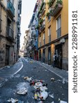 Small photo of PAMPLONA, Spain - July 07 2022: The streets of Pamplona, ​​in the morning, after the end of the first day of San Fermin. Garbage thrown on the street, unbearable smell. Deplorable aspect of the city
