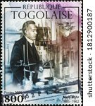 Small photo of Milan, Italy - August 01, 2020: Scientist Niels Bohr in his laboratory on postage stamp