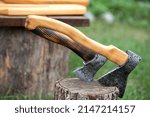 Small photo of Outdoors displays handcrafted wood and metal crafts, natural wood cutting boards and axes