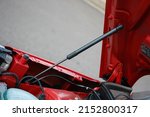 Small photo of Gas bonnet strut of a new red vehicle
