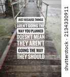 Small photo of Blurry wooden bridge background with inspirational quotes - Just because things aren't going the way you planned doesn't mean they aren't going the way they should.