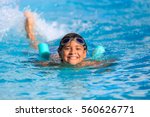 Boy happy swimming in a pool 