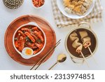 Small photo of topokki or tteokbokki with boiled egg on a white plate. served with odeng, kimchi, and cheese topokki. flat lay angle. perfect for recipe, article, catalogue, commercial, or any cooking contents.