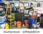 Messy cluttered garage filled with various household storage items.