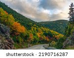 Small photo of A two-lane highway winds through colorful autumn foliage at Crawford's Notch in New Hampshire's White Mountains.
