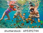 Happy family - father, mother, child in snorkeling mask dive underwater with tropical fishes in coral reef sea pool. Travel lifestyle, water sport adventure, swimming on summer beach holiday with kids