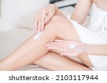 Woman applying cream,lotion on leg with white background, Beauty concept.