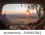 Sunset seen from the back of a camper with amazing landscape. Adventure trip with amazing feeling. Concept of nature and having freedom in holiday
