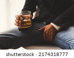 Small photo of Alcoholism concept. Young man drinking alcohol too much. Alcoholic with a glass of whiskey, Impotence and Erectile dysfunction (ED) concept.