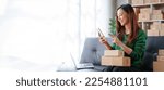 Small photo of Portrait of Starting small businesses SME owners female entrepreneurs working on receipt box and check online orders to prepare to pack the boxes, sell to customers, SME business ideas online.