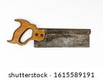 Small photo of Traditional vintage wooden handled short backsaw with a rusty metal blade shot from above in a white studio.