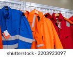 Jackets with reflective stripes - road workers special clothing. Workwear, protection clothing and outfit concept