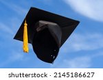 Graduation Caps Thrown in the Air blue sky on background