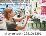 Woman buying toilet paper in a store