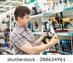 Man shopping for perforator in hardware store close-up