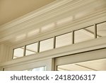 Small photo of Elegant Crown Molding and Transom Windows Interior Detail