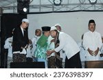 Small photo of Kajen , Indonesia - September 16 , 2023 The Ustadz and residents shook hands on the stage