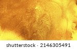 Small photo of Glitter fluid. Wet ink texture. Shiny liquid spill. Glossy polish. Defocused golden color shimmering paint flow abstract art background.