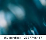 Small photo of Defocused glow background. Light flare. Beam reflection. Blur white teal blue color smeared glare flecks on dark abstract copy space texture.