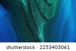 Small photo of Glitter ink. Abstract background. Sparkling wave. Defocused shiny shimmering green blue color liquid paint blend grain texture with free space.