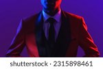 Small photo of Gentleman fashion. Dandy style. Party look. Neon light unrecognizable confident man in red elegant tuxedo suit on dark fluorescent purple color background.