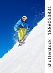Small photo of Male snowboarder riding snowboard fast down steep snowy mountain slope, jumping in air on copy space background of blue sky and white snow on sunny winter day. Extreme sport and recreation concept.