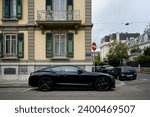 Small photo of Geneva, Switzerland - September 10th 2023 - "Stunning black Bentley, parked on the streets of Geneva, showcasing affluence and style.