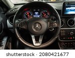 Small photo of St Petersburg, Russia - October 31, 2021: Mercedes-Benz A-Class 180 III W176 Restyling steering wheel, dashboard, badge, odometer, tachometer