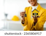 Small photo of African American female real estate agent delivers house model to client mortgage loan contract Make a contract to buy and sell a house. and home insurance contract home mortgage loan concept