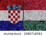 Croatia and Hungary painted flags on a wall with grunge texture. Hungary and Croatia conflict. Croatia and Hungary flags together. Hungary vs Croatia