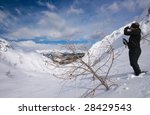 Woman resting and drinking hot tea in high alps in snow