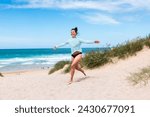Happy young woman at seaside in ...
