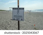Small photo of Queens, NY - August 13, 2021: Sign reads "Restricted Area: Seabeach Amaranth" at Rockaway Beach