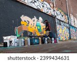 Small photo of A graffiti artist spry paint a wall - 07.09.2023 Amsterdam