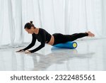 Small photo of Pilates woman roller swan roll exercise workout. Fealty lifestyle.