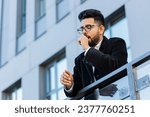Small photo of Tired exhausted Indian businessman yawning, sleepy inattentive feeling somnolent lazy bored gaping suffering from lack of sleep, falling asleep outdoors. Arabian Hindu freelancer guy in downtown city