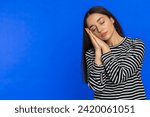 Small photo of Tired exhausted young Caucasian woman yawning sleepy inattentive feeling somnolent lazy bored gaping suffering from lack of sleep insomnia. Brunette girl isolated on blue studio background. Copy-space