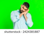 Small photo of Tired exhausted Indian young man sleepy inattentive feeling somnolent lazy bored gaping suffering from lack of sleep, falling asleep. Arabian guy isolated on green chroma key background