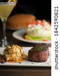 Small photo of Surf and turf. Steak and lobster tail entree. Filet mignon topped with mushrooms served with lobster tail and topped with drawn butter. Classic steakhouse or French bistro entree.