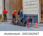 Small photo of February- 1- 2024- Paris France -Champs-Elysees-Workers equipped with a thick wire brush unravel a canal