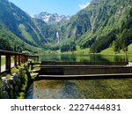 scenic alpine landscape with a waterfall, a transparent alpine lake and several trout breeding ponds in the Austrian Alps of the Schladming-Dachtein region in Styria or Steiermark in Austria