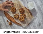 Small photo of Cookies with chocolate dibs on bright background with milk