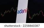 Small photo of Jakarta - February 07,2023: Adani group logo and stock market downtrend chart. Adani stock market crush. Adani Group is an Indian multinational conglomerate,with the flagship company Adani Enterprises