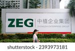 Small photo of Jakarta - November 28, 2023: A woman passing through in front of Zhongzhi Enterprise Group sign board. is a leading Chinese asset management corporation headquartered in Beijing.