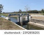 Small photo of Beautiful view of a small river in a rice field area with a blue floodgate