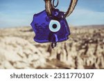 Small photo of Evil eye, talismans to ward off the evil eye, on the branches of a tree in Cappadocia, Turkey Evil eye bead selective focus for good luck in Cappadocia Turkey